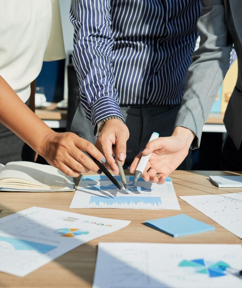 Cropped image of business executives analyzing financial statistics